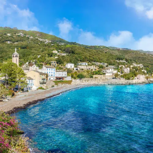 Vue sur une crique avec un petit village en bord de mer